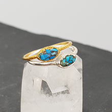 Load image into Gallery viewer, marquise Mohave turquoise raw gold and silver ring displayed on a crystal
