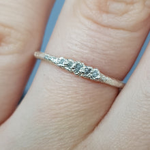 Load image into Gallery viewer, raw white diamond and silver eternity ring, handmade in the UK, worn on a woman&#39;s finger
