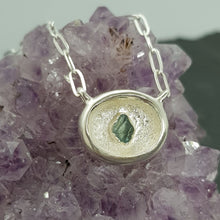 Load image into Gallery viewer, raw apatite silver necklace from the crevice collection on a crystal
