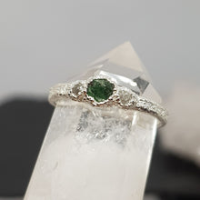 Load image into Gallery viewer, raw emerald and diamond silver ring displayed on a crystal
