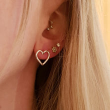 Load image into Gallery viewer, sterling silver heart stud earrings on model
