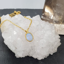 Load image into Gallery viewer, moonstone gold pebble necklace displayed on a crystal
