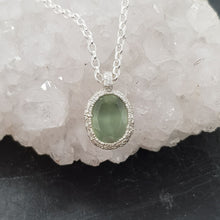 Load image into Gallery viewer, green prehnite textured silver pebble necklace displayed on a crystal
