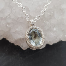 Load image into Gallery viewer, salt and pepper aquamarine raw silver necklace displayed on a crystal
