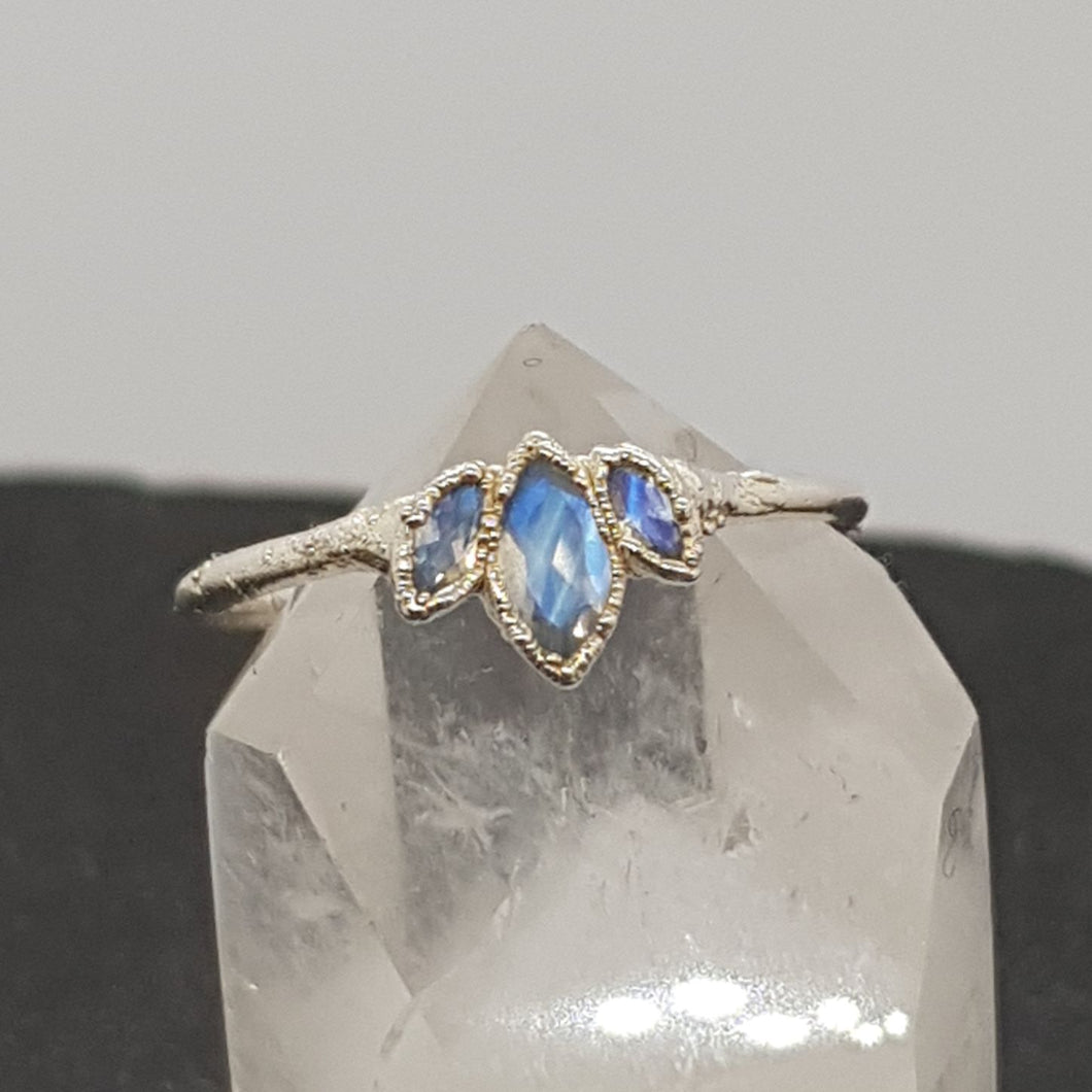 triple marquise moonstone silver ring, handmade in the UK, displayed on crystal